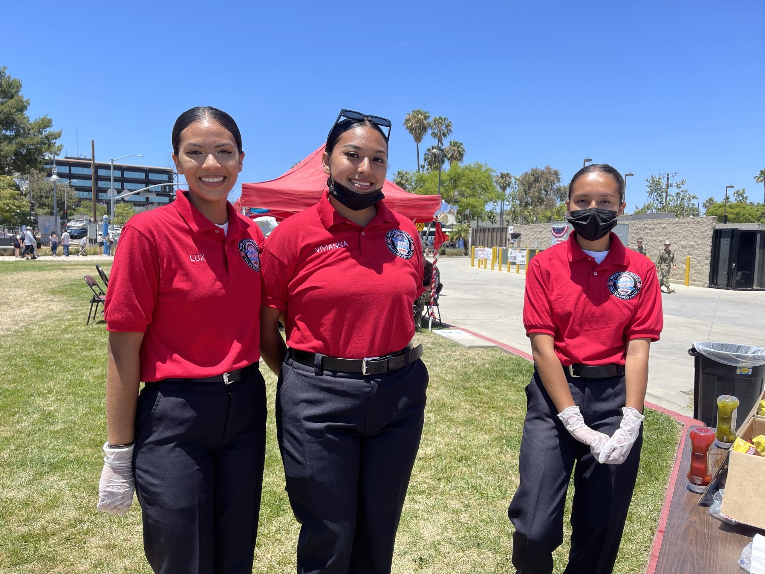 A Group of Women Wearing Red Shirts and Black Pants